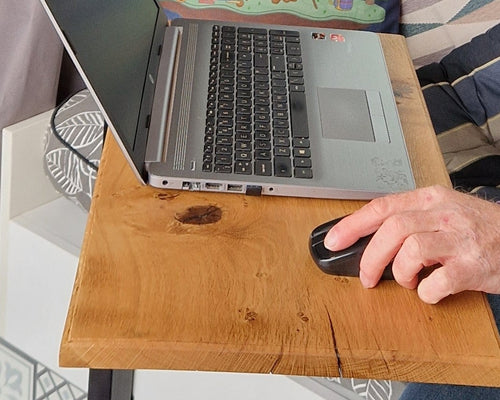 Handcrafted solid oak campervan laptop table in use inside a van conversion, showing natural wood grain and compact workspace design.