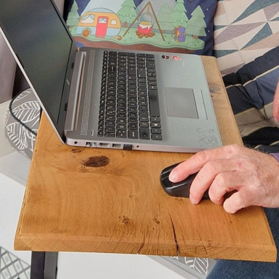 Handcrafted solid oak campervan table in use with laptop and coffee inside a UK van conversion.