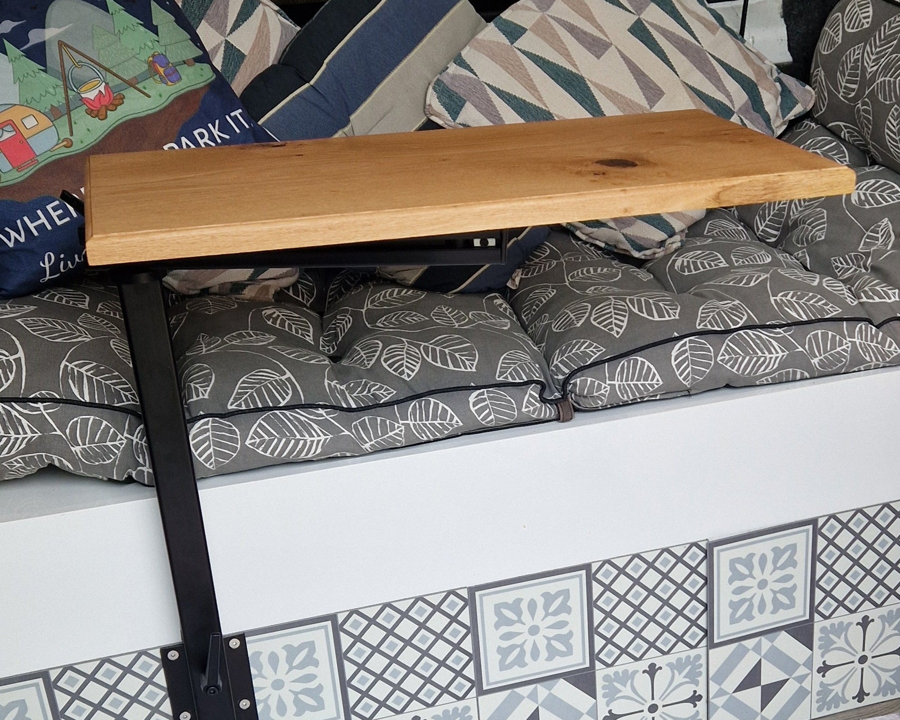 Side profile of handcrafted solid oak campervan table showing thickness, edge detail and natural wood grain inside a van conversion.